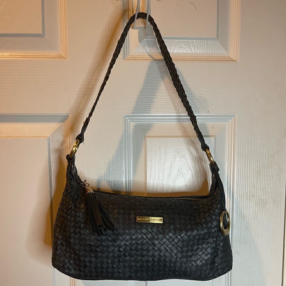 Elliott Lucca leather black woven shoulder bag with tassel accent .